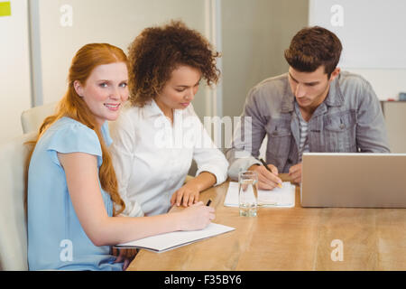 Imprenditrice sorridente con i colleghi in riunione Foto Stock