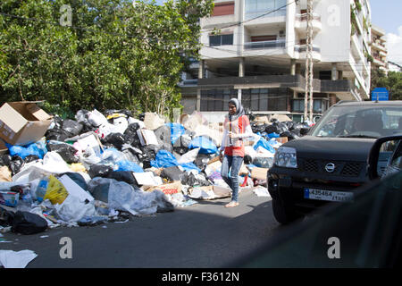 Beirut Libano. Il 30 settembre 2015. Un pedone passato passeggiate cumuli di rifiuti non riscossi marciume nell'estate calore dai rifiuti libanese crisi che ha scatenato le proteste civili da "Si Stink' circolazione Credito: amer ghazzal/Alamy Live News Foto Stock