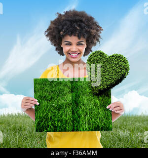 Immagine composita della donna azienda prato prenota Foto Stock