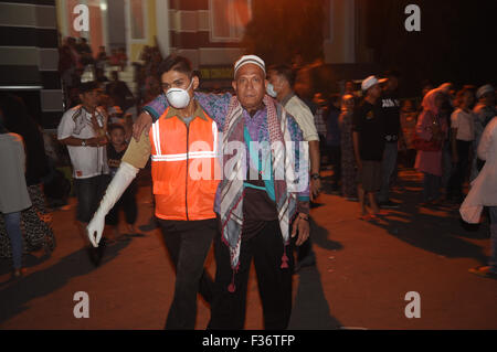 Makassar, Indonesia. 30 Settembre, 2015. Un ufficiale medico assiste un hajj indonesiano per avere l'esame a causa di problemi di salute subito dopo arrivano a Sudiang Hajj Ostello a Makassar, Indonesia il 30 settembre 2015. Indonesia defunti 168.800 hajj pellegrino in Arabia Saudita quest'anno, ma ci si aspetta hudred del pellegrino morti durante rencent hajj stagione. Indonesiano Afair religiosa non ha confermare il numero esatto di hajj morti dovuti alla raccolta di dati corretti a seguito della tragedia di Mina che ha ucciso circa 1000 pellegrino. Credito: Yermia Riezky Santiago/Alamy Live News Foto Stock