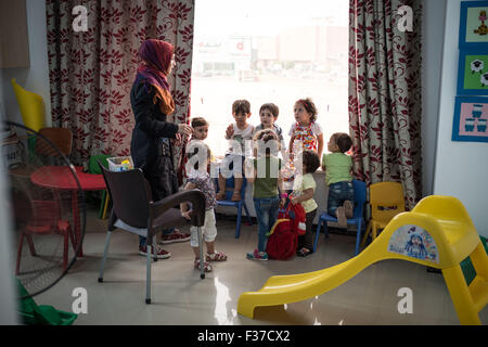 Il Cairo, Egitto. Il 30 settembre, 2015. Bambini siriano parla con un insegnante presso una scuola privata fondata da un mercante siriano del 6 ottobre città del Cairo, Egitto, sul Sett. 30, 2015. Oltre 130.000 registrati rifugiati siriano, tra cui 58.000 sono bambini, vivono attualmente in Egitto, secondo l UNHCR, i dati più recenti. Gli studenti siriani è difficile ottenere una corretta educazione per varie ragioni tra cui short risorsa dal governo egiziano, nonché le differenze tra i due paesi nel curriculum, la lingua e lo stile di vita. © Pan Chaoyue/Xinhua/Alamy Live News Foto Stock