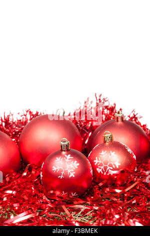 Rosso cinque palle di Natale e tinsel isolati su sfondo bianco Foto Stock