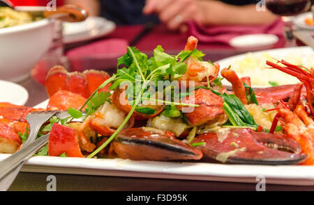 Piastra di aragosta fritta in un wok con coriandolo Foto Stock