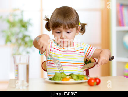 Kid mangiare cibo sano a casa o asilo nido Foto Stock