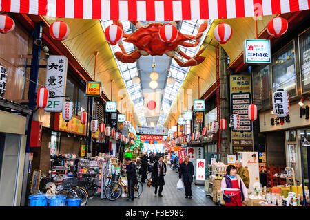 "Kuromon Ichiba', noto come Osaka cucina dell'interno di un lungo porticato coperto di negozi e bancarelle che vendono cibo, ma famoso per i suoi piatti di pesce. Non occupato. Foto Stock