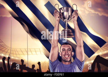 Immagine composita del ritratto di sorridere giocatore di rugby trofeo di contenimento Foto Stock