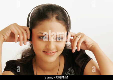 Maharashtrian ragazza adolescente assorto in ascolto di musica con cuffie signor#686M Foto Stock