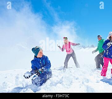 Famiglia avente lotta con le palle di neve, Chamonix, Francia Foto Stock