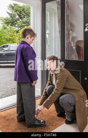 Madre figlio ottenere pronto per la scuola Foto Stock