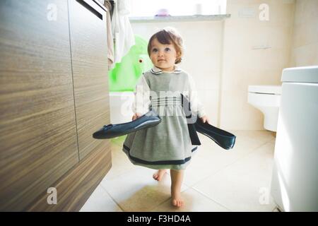 Toddler femmina porta scarpe da donna a casa Foto Stock