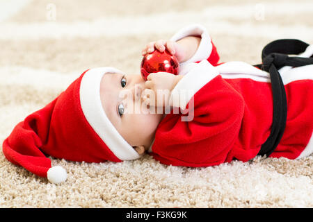 Baby boy usurata Santa hollding PALLA DI NATALE Foto Stock