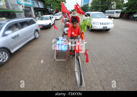 (151009) -- YANGON, il 9 ottobre, 2015 (Xinhua) -- i sostenitori del Myanmar il partito di opposizione, Lega Nazionale per la democrazia (NLD), equitazione NLD bandiera-decorate trishaws, prendere parte a una campagna di rally per il prossimo novembre 8 elezioni generali in Yangon, Myanmar, Ottobre 9, 2015. Dei 1.130 NLD candidati, 318 saranno in concorrenza per i sedili con la Casa dei Rappresentanti (Casa inferiore), 163 con la casa di nazionalità (Upper House), 620 con la regione o lo Stato europeo e 29 con rappresentanti di etnia. (Xinhua/U Aung)(azp) Foto Stock