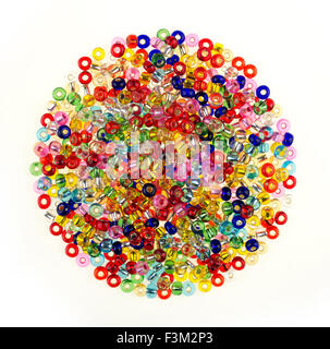 Pila tonda colorati di perline di vetro per DIY gioielleria, isolato su sfondo bianco Foto Stock