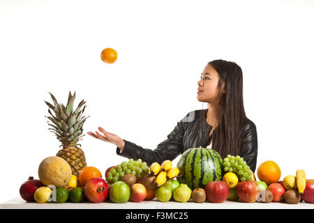 Molti frutti impilati insieme e carina ragazza Foto Stock