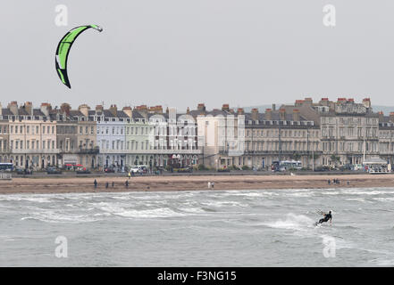 Kite surfer gode il tempo ventoso, porto di Weymouth Dorset, Gran Bretagna, Regno Unito Foto Stock