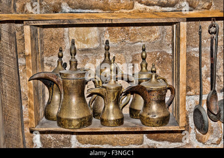 Spazzatura negozio pieno di cose che sono a raccogliere polvere sugli scaffali. Bronza e utensili di rame, stufe e stufa a kerosene Foto Stock