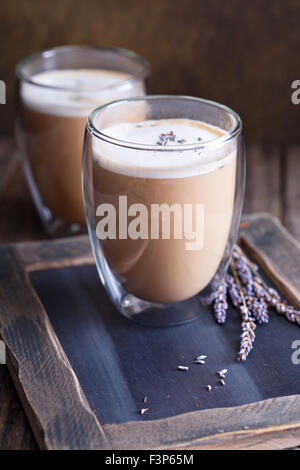 Latte caldo in grande doppia parete a vetri con lavanda essiccata Foto Stock