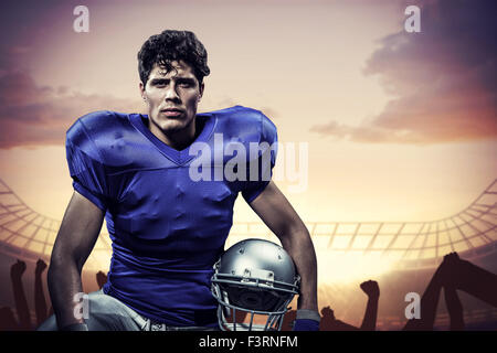 Immagine composita del ritratto di serio sportivo con mano sul ginocchio casco di contenimento Foto Stock