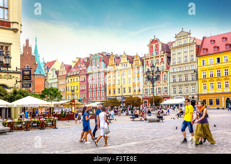 Belle case tenements e turisti a piedi la piazza del vecchio mercato a Wroclaw in Polonia Foto Stock