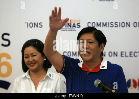 Manila, Filippine. Xiii oct, 2015. Il Senatore filippino Ferdinand Marcos Jr. (R), figlio del defunto presidente Ferdinando Marcos, onde dopo il deposito del suo certificato di candidatura per il vice-presidente della Commissione sulle elezioni edificio a Manila nelle Filippine, 13 ottobre, 2015. Ci sono state relazioni precedenti che egli avrebbe dovuto correre per il presidente ma poiché egli era un povero che mostra nelle indagini, ha deciso di stabilirsi per la seconda posizione più alta nelle Filippine. © Rouelle Umali/Xinhua/Alamy Live News Foto Stock