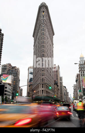 Il traffico si muove sulla strada vicino a Flatiron Building a Manhattan, New York New York, Stati Uniti d'America Foto Stock