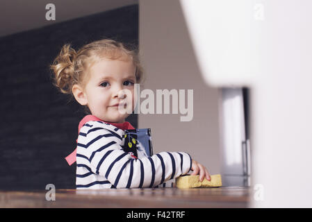 Bambina aiutando con lavori di casa, ritratto Foto Stock
