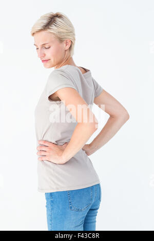 Donna bionda che soffrono di dolori alla schiena Foto Stock
