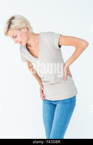 La donna che soffre di dolori alla schiena Foto Stock