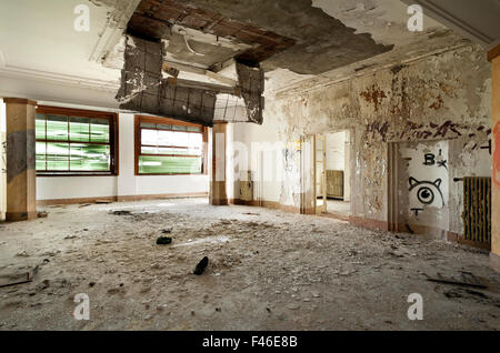 Edificio abbandonato, camera grande, detriti sul pavimento Foto Stock