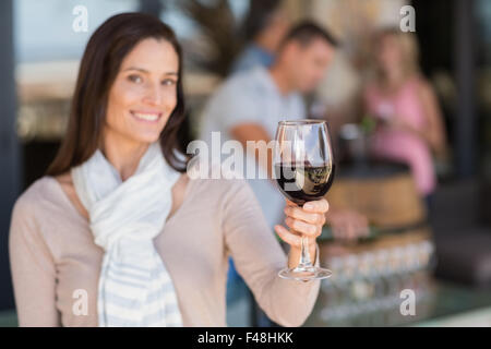 Ritratto di donna sorridente tostare in parte anteriore del sommelier e giovane bere il vino Foto Stock