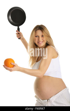 Donna incinta giocando a tennis arancione e il pan Foto Stock