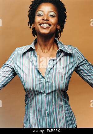 Ritratto di un sorridente con la pelle scura la donna in una camicia a righe. Foto Stock