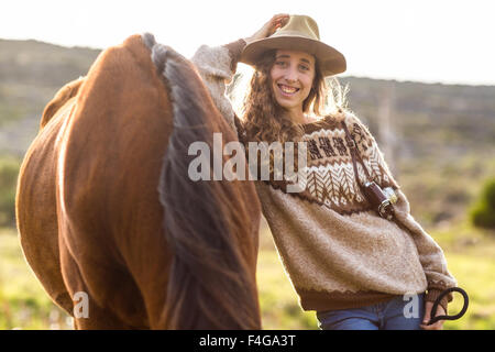 Giovane donna sorridente con il suo cavallo Foto Stock