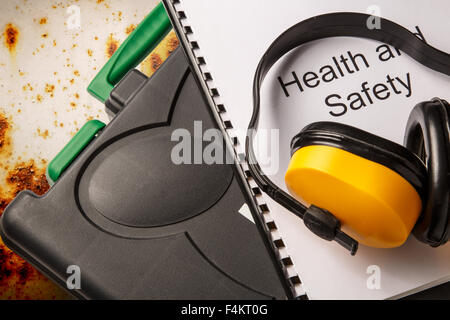 La casella degli strumenti di colore nero con gli auricolari e la salute e sicurezza documento Foto Stock