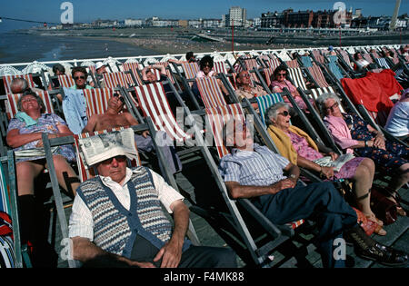 August Bank Holiday Maker a prendere il sole in sedie a sdraio sul Blackpool North Pier, balneare inglese, Lancashire, Inghilterra, Regno Unito Foto Stock
