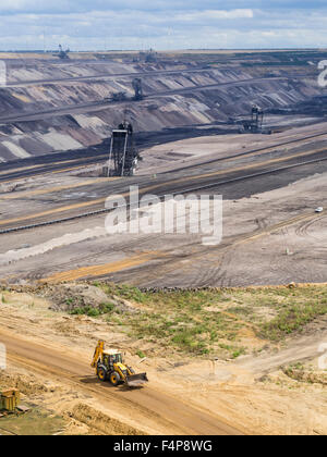 Benna-escavatori gommati nel paesaggio cratered della superficie campo minerario a Garzweiler, più grande della Germania a cielo aperto pit. Foto Stock