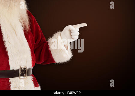 Immagine composita di santa claus punti a qualcosa di Foto Stock