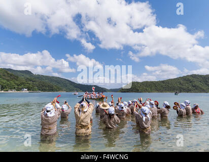 Shioya Ungami, un festival annuale di Ogimi Village, Okinawa. Donne locali di cantare e ballare in acqua come il dragon boat race. Foto Stock