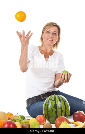 Molti frutti impilati insieme e carino donna Foto Stock