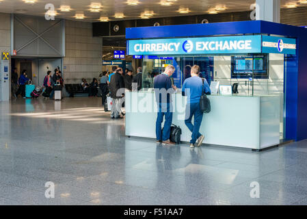 Due uomini stanno cambiando il denaro a un cambio valuta boot al Terminal 1 dell'aeroporto internazionale di Francoforte Foto Stock