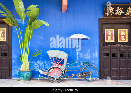 Georgetown, Malesia - 04 August, 2014: vecchi rickshaw triciclo vicino Fatt Tze Mansion o Blu Mansion, famoso storico orientale Foto Stock