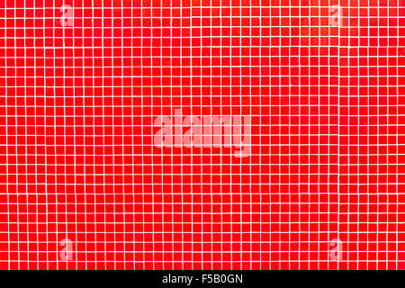 Vero mosaico rosso sfondo. Rosso di piastrelle di vetro su bianco mortaio con graffi e imperfezioni. Nessuna luce riflessi. Foto Stock