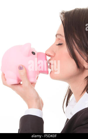 Donna felice kissing piggy Foto Stock