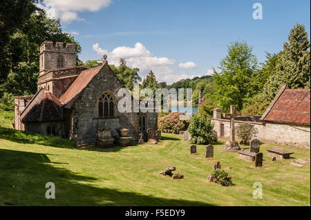 Stourhead, Wiltshire, Regno Unito. Una vista in lontananza il famoso giardino paesaggistico dalla chiesa di San Pietro in Stourhead village Foto Stock