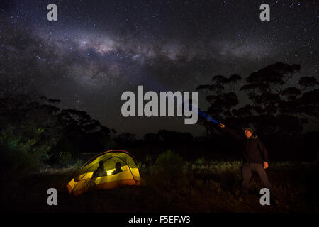 Uomo con torcia e due uomini in una tenda, Gawler Ranges, Australia Foto Stock