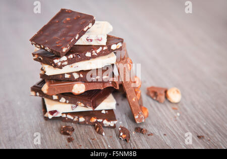 Pezzi di cioccolato sulla tavola di legno Foto Stock