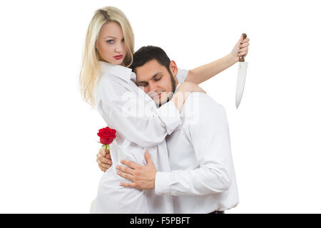 Ragazza con il coltello traditore. l uomo con rosa in mano. Sfondo bianco Foto Stock