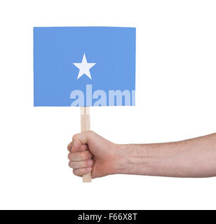Mano azienda piccola scheda, isolato su bianco - la bandiera della Somalia Foto Stock