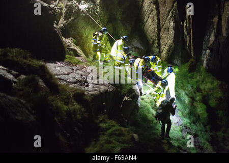 Sabato 14 novembre 2015, Cornwall, Regno Unito H.M Coastguard salvataggio di un alpinista ferito durante un 3hr incidente di notte, in cattive condizioni atmosferiche. Studente Davis, 20 anni, è liberato dopo il mantenimento di una caviglia infortunata a seguito di una caduta durante la salita Bosigran dorsale nei pressi di San Giusto. Non in grado di auto-districarsi, cliff il personale di soccorso assistere i suoi progressi su roccia ripida e vegetazione utilizzando la corda-tecniche di salvataggio, prima di trasportarlo su terreni sconnessi paludosa terra per un ambulanza in attesa. Foto Stock