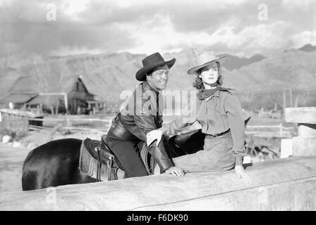 Data di rilascio: maggio 30, 1941. Il titolo del filmato: Billy the Kid. STUDIO: Metro Goldwyn Mayer (MGM). Trama: . Nella foto: Robert TAYLOR come Billy Bonney e MARIA HOWARD come Edith Keating. Foto Stock